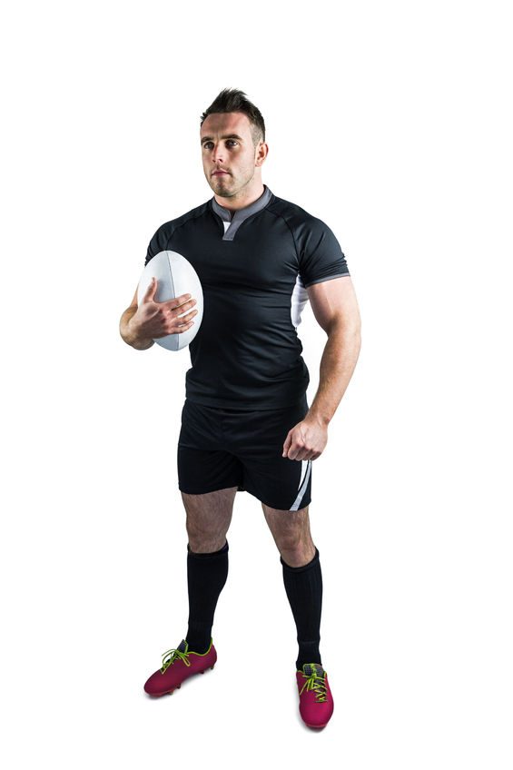 44459336 - tough rugby player holding ball on white background